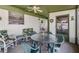Relaxing screened porch with comfortable seating and a ceiling fan for a cool breeze at 7045 El Dewitt St, Zephyrhills, FL 33541