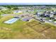Aerial view of a community with a dog park, pool, playground, and green space at 7164 Twisting Pines Loop, Zephyrhills, FL 33541