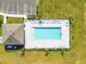 Aerial view of a community pool with lounge chairs and cabana with parking at 7164 Twisting Pines Loop, Zephyrhills, FL 33541