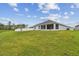 A vast backyard with plush green grass and a view of the home at 7164 Twisting Pines Loop, Zephyrhills, FL 33541
