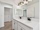 Bright bathroom with a double sink vanity, modern lighting, and sleek fixtures for added functionality at 7164 Twisting Pines Loop, Zephyrhills, FL 33541
