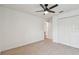 A bright room with a ceiling fan, closet, and neutral carpeting at 7164 Twisting Pines Loop, Zephyrhills, FL 33541