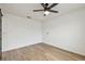 A clean and bright room featuring modern ceiling fan and wood-look flooring at 7164 Twisting Pines Loop, Zephyrhills, FL 33541