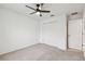 Bright bedroom with neutral carpet, a modern ceiling fan, and a closet with double doors at 7164 Twisting Pines Loop, Zephyrhills, FL 33541