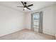 Neutral bedroom with ceiling fan, carpet, a window with blinds and curtains, and closet at 7164 Twisting Pines Loop, Zephyrhills, FL 33541