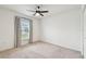 Bright bedroom with a ceiling fan, window with curtains, and neutral carpeting at 7164 Twisting Pines Loop, Zephyrhills, FL 33541