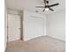 A well-lit bedroom with carpet, closet and a ceiling fan at 7164 Twisting Pines Loop, Zephyrhills, FL 33541