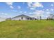 Exterior of home with green lawn, screened in porch, and modern white color at 7164 Twisting Pines Loop, Zephyrhills, FL 33541