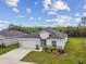 Charming single-story home featuring a well-manicured lawn and an attached two-car garage at 7164 Twisting Pines Loop, Zephyrhills, FL 33541