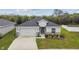 Single-story home shows an attached two-car garage, appealing stone accents, and a well-kept front yard at 7164 Twisting Pines Loop, Zephyrhills, FL 33541