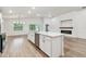Bright kitchen with a large island, stainless steel appliances, and modern finishes in an open layout at 7164 Twisting Pines Loop, Zephyrhills, FL 33541