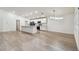 Open kitchen with white cabinets, modern appliances, an island, and modern lighting at 7164 Twisting Pines Loop, Zephyrhills, FL 33541