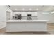 Open kitchen with a large island, stainless steel appliances, and a white countertop at 7164 Twisting Pines Loop, Zephyrhills, FL 33541