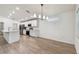 Bright, open kitchen with an island, stainless steel appliances, and a modern chandelier at 7164 Twisting Pines Loop, Zephyrhills, FL 33541