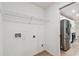 This laundry room has a wire shelf for storage and washer/dryer hookups at 7164 Twisting Pines Loop, Zephyrhills, FL 33541