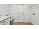 Bright laundry room features a utility sink and wood look floors at 7164 Twisting Pines Loop, Zephyrhills, FL 33541