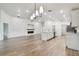 Spacious living room and kitchen with shiplap walls and a modern fireplace, featuring a large central island at 7164 Twisting Pines Loop, Zephyrhills, FL 33541