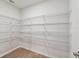 Walk-in pantry with white wire shelving for ample storage at 7164 Twisting Pines Loop, Zephyrhills, FL 33541