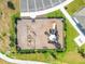 Overhead view of a mulched playground area with green grass, bordered by shrubbery and equipped with various play structures at 7164 Twisting Pines Loop, Zephyrhills, FL 33541