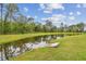 Scenic pond bordered by lush greenery offers a serene view at 7164 Twisting Pines Loop, Zephyrhills, FL 33541