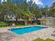 Community pool with a shallow end, ladder, and plenty of deck space at 7164 Twisting Pines Loop, Zephyrhills, FL 33541