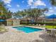 Inviting community pool area with lounge chairs, tables, and a pool house at 7164 Twisting Pines Loop, Zephyrhills, FL 33541