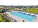 Community pool with ample seating and lounge chairs, perfect for relaxing at 7164 Twisting Pines Loop, Zephyrhills, FL 33541