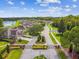 Street view of gated community with manicured landscaping and pond in the background at 7164 Twisting Pines Loop, Zephyrhills, FL 33541