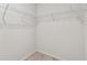 An empty carpeted walk-in closet with white walls and wire shelving ready for organizing clothes at 7164 Twisting Pines Loop, Zephyrhills, FL 33541