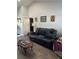 Cozy living room with a comfortable black leather sofa at 7723 Mitchell Ranch Rd, New Port Richey, FL 34655