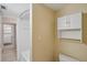 Clean bathroom showing tub/shower combo, toilet, and storage above at 806 Linwood Ter, Lutz, FL 33549