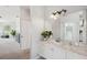 Charming bathroom with a vanity and a mirror, with a glimpse into the hallway and other rooms at 806 Linwood Ter, Lutz, FL 33549