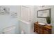 Bathroom offers an antique vanity with vessel sink, decorative mirror, and black and white tile flooring at 806 Linwood Ter, Lutz, FL 33549