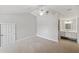Bedroom featuring neutral carpet, white trim and ensuite bathroom at 806 Linwood Ter, Lutz, FL 33549