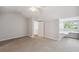 Bedroom featuring built-in desk, neutral carpet, and window at 806 Linwood Ter, Lutz, FL 33549