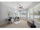 Bright bedroom features a ceiling fan, windows, plush chairs, and a decorative mirror for added style at 806 Linwood Ter, Lutz, FL 33549