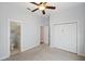 Bright bedroom features light-colored walls, carpet flooring, ceiling fan and direct access to the bathroom at 806 Linwood Ter, Lutz, FL 33549