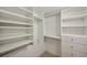 Well-organized walk-in closet offers ample storage with shelves and drawers at 806 Linwood Ter, Lutz, FL 33549