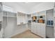 Bright walk-in closet with custom shelving, drawers, rod and carpeted floor at 806 Linwood Ter, Lutz, FL 33549