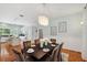 Dining room with hardwood floors, chandelier, and is connected to the kitchen at 806 Linwood Ter, Lutz, FL 33549