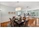 Open dining room with hardwood floors, chandelier and is connected to the kitchen at 806 Linwood Ter, Lutz, FL 33549