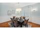 Dining room with hardwood floors, modern chandelier and light blue walls at 806 Linwood Ter, Lutz, FL 33549