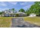 Beautiful single-Gathering home featuring a long driveway, well-manicured lawn, and a detached garage at 806 Linwood Ter, Lutz, FL 33549