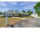 Charming exterior of the single-Gathering home with a long driveway and manicured landscaping at 806 Linwood Ter, Lutz, FL 33549
