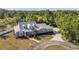 An inviting home featuring a curved driveway, dormer windows, and lush landscaping enhancing its curb appeal at 806 Linwood Ter, Lutz, FL 33549