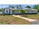 Charming single Gathering home featuring manicured landscaping and a inviting walkway to the front door at 806 Linwood Ter, Lutz, FL 33549