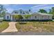 Street view of single Gathering home featuring manicured landscaping and a walkway to the front door at 806 Linwood Ter, Lutz, FL 33549