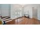 Foyer with hardwood flooring, stairs to the left and a glass front door at 806 Linwood Ter, Lutz, FL 33549