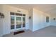 Inviting front entrance with a glass-paneled door and white siding, number 806, and sconce lighting at 806 Linwood Ter, Lutz, FL 33549