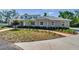 Well-maintained front yard with a concrete walkway leading up to a charming single-story home at 806 Linwood Ter, Lutz, FL 33549